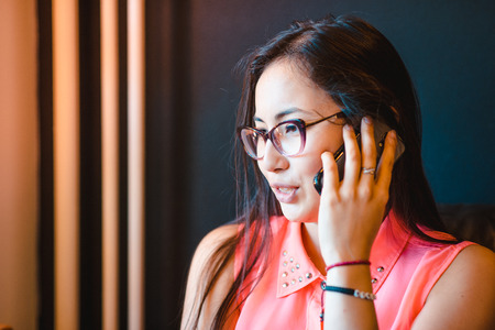 girl speaks by phone emotionallyの写真素材