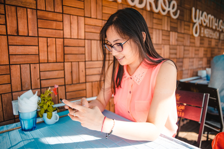 girl with glasses writes sms stressの写真素材