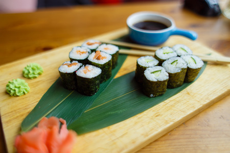 sushi with fish on a wooden board