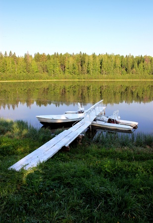 Landscape of an old pond with boats at the coast   の写真素材
