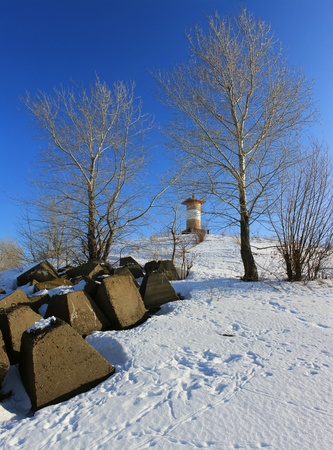 Winter landscape with a lighthouse on the shore   の写真素材