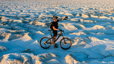 View of cyclist racing on the bicycle in desert. Outdoor sports, cycling, tourismの写真素材