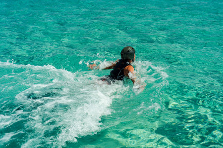 Man in helmet before flyboarding in blue seaの写真素材