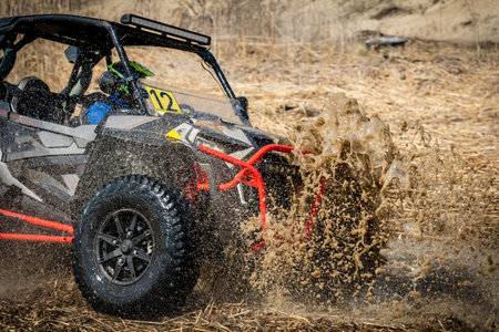 Active ATV and UTV Off-Road vehicle in muddy water. ATV 4x4