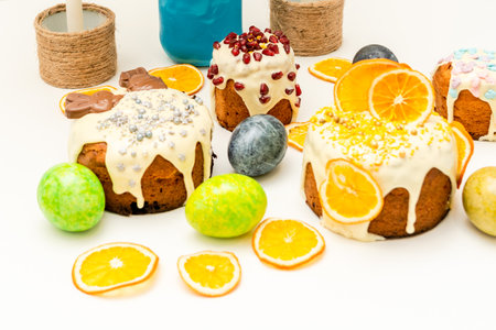 Set of traditional decorated easter cakes with icing and colored eggs. A Symbol of holiday and Easter treatの写真素材
