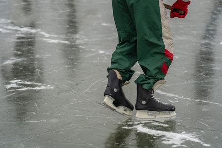 Close-up of people skating and playing amateur hockey on frozen lake