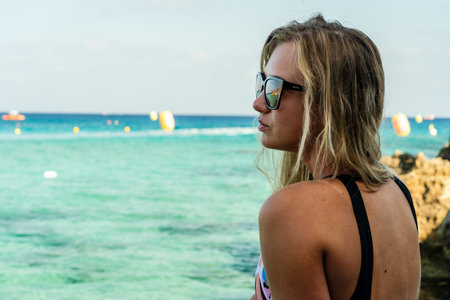Beautiful blond girl near the crystal blue sea