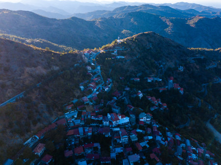 Aerial view above a rural hilly village with red brown roofsの写真素材