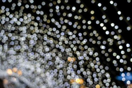 Abstract bokeh of white lights on black background. Christmas Lights