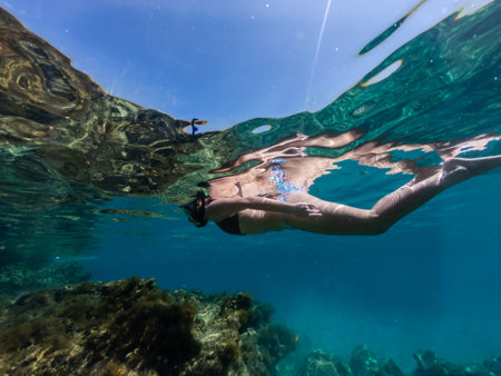 Woman snorkeling around coral reef. Underwater photoの写真素材