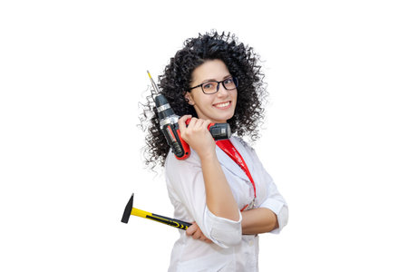 Young girl with screw gun and tools. Ready for repair. Isolatedの写真素材