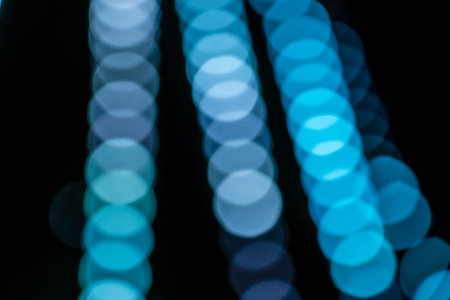 Blue abstract bokeh lights with black backgroundの写真素材