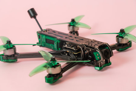 A Close up view on modern drone with camera isolated on pink backgroundの写真素材