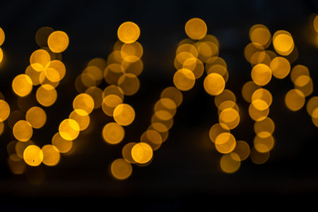 Yellow glitter vintage lights with black background. Defocusedの写真素材