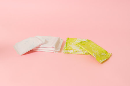 Flat layout of sanitary napkins on a pink background. Menstruation cycle, feminine hygiene and...