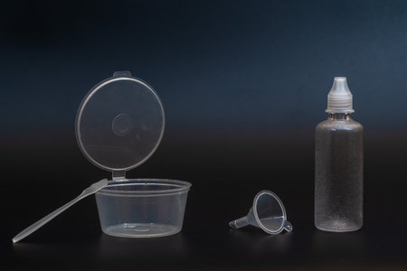 Transparent plastic tubes and shoulder blade on black background