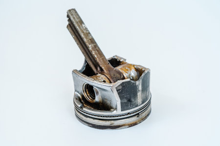 Broken connecting rod and engine piston isolated on white backgroundの写真素材