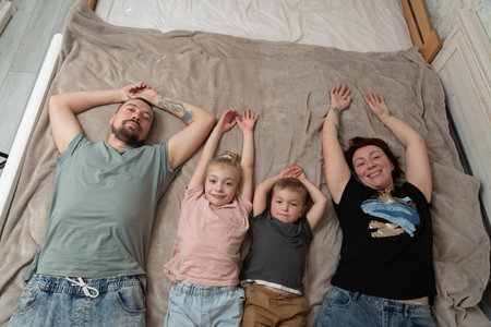 Smiling parents having fun with kids at a home. Happy family moments