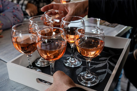 Rose wine tasting, glasses of rose wine on a wood trayの写真素材