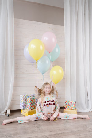 Amazing small birthday girl at a home. Decoration and photo zone for girls birthday partyの写真素材