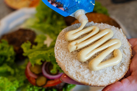 A Close up view on preparing cheeseburger with vegetables and meatの写真素材