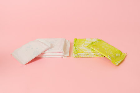 Flat layout of sanitary napkins on a pink background. Menstruation cycle, feminine hygiene and protectionの写真素材