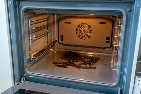 Close up inside view of dirty oven with deposits on a bottomの写真素材