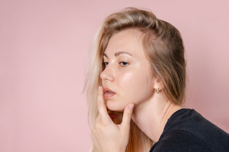 Attractive sensual young blond woman. Beauty woman portrait. A Pink background. Nude or no makeupの写真素材