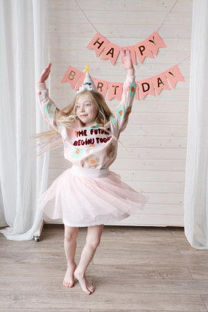 Amazing small birthday girl at a home. Decoration and photo zone for girls birthday partyの写真素材
