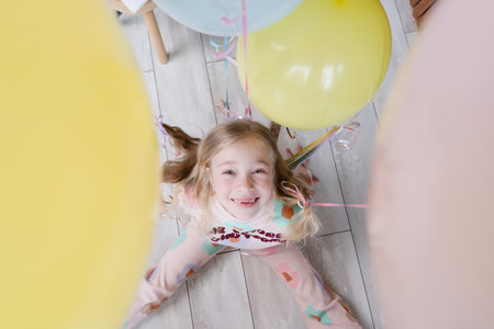 Happy girl with balloons on the her hair