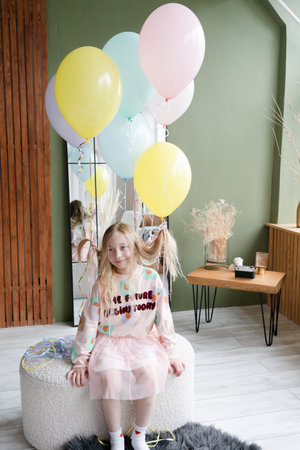 Amazing small birthday girl at a home. Decoration and photo zone for girls birthday partyの写真素材