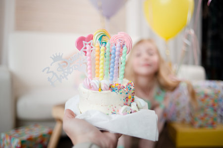 Happy small girl with a birthday cake