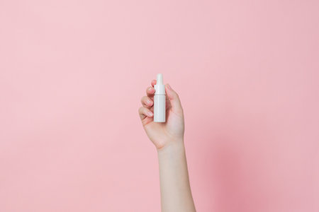 Glass bottle with serum or essential oil with pipette on a gentle background. Presenting skincare productsの写真素材