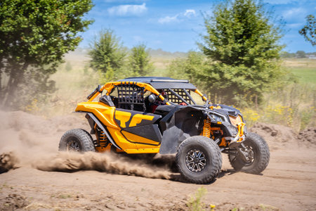 UTV buggy moves on a dusty road. 4x4, extreme, adrenalin.
