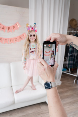 Happy blond girl celebrating birthday. Decoration and photo zone for the girls birthday party