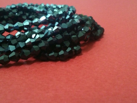 Shiny beaded necklaces on red backgroundの素材