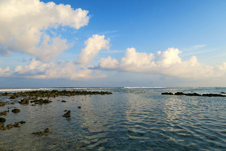 Local surfing spot on Himmafushi island, Maldives: clouds reflection in oceanの写真素材
