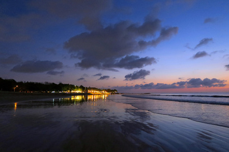 Night lights reflection after sunset at Kuta beach, Bali, Indonesiaの写真素材