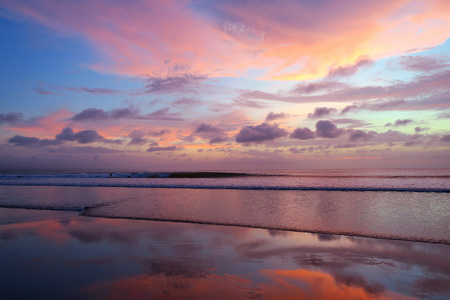 Violet sky and mirror reflection sunset at Kuta beach, Bali, Indonesiaの写真素材