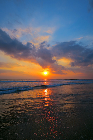 Amazing colors of beautiful sunset at Kuta beach, Bali, Indonesiaの写真素材
