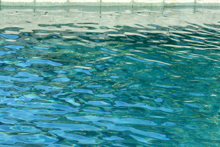 Swimming pool water surface with rippleの写真素材