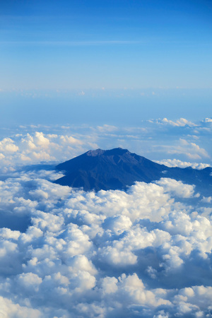 Mountain peak in clouds, aerial view from plane windowの写真素材