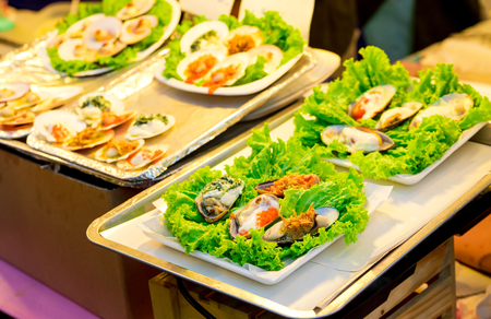 The menu included baked mussels and decorated with lettuce.の写真素材