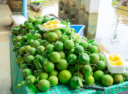 Grapefruits pile on the table and the fruits is sold in the market.のeditorial素材