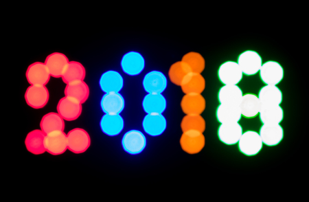 Happy New Year 2018. Make by colorful LED light sparkling bokeh number on black background.の写真素材