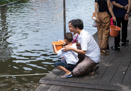 Teparak,Samut Prakan,Thailand-July 9.2017: People bring their families come to worship, make merit at the temple on the Buddhist Lent Day and release aquatic animals with feeding fish.のeditorial素材