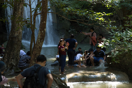 Erawan waterfall, Si Sawat District, Kanchanaburi, Thailand-January 01.2018. Group of tourists are playing water in area of the cascade. There are shades of forest.のeditorial素材