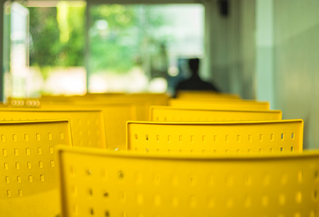 Close up view. Yellow empty chairs in a row in the reception room.の写真素材