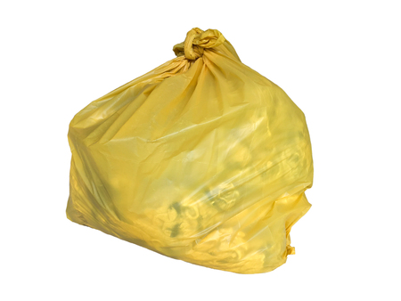 Yellow plastic bag for packaging waste with rag to recycle isolated on white background.の写真素材