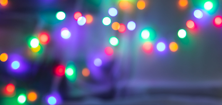 Colorful bokeh background made by bulbs. In dark shadow. Low light.